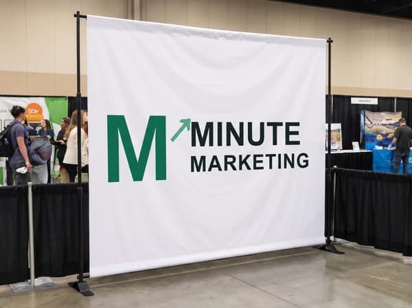 White fabric display banner on a black support stand.