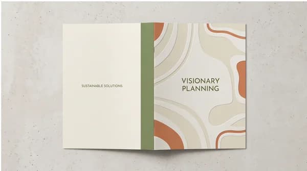 Front and back artwork of a custom printed folder on a studio surface.