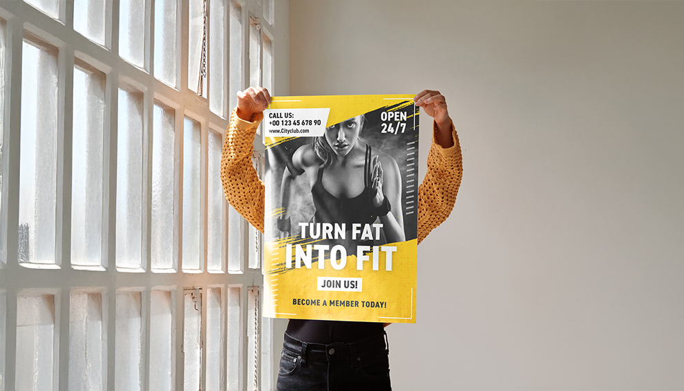 Person holding a fitness poster