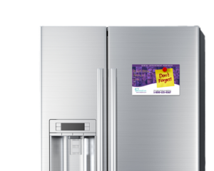 Dental appointment reminder postcard with magnet backing displayed on a kitchen refrigerator.