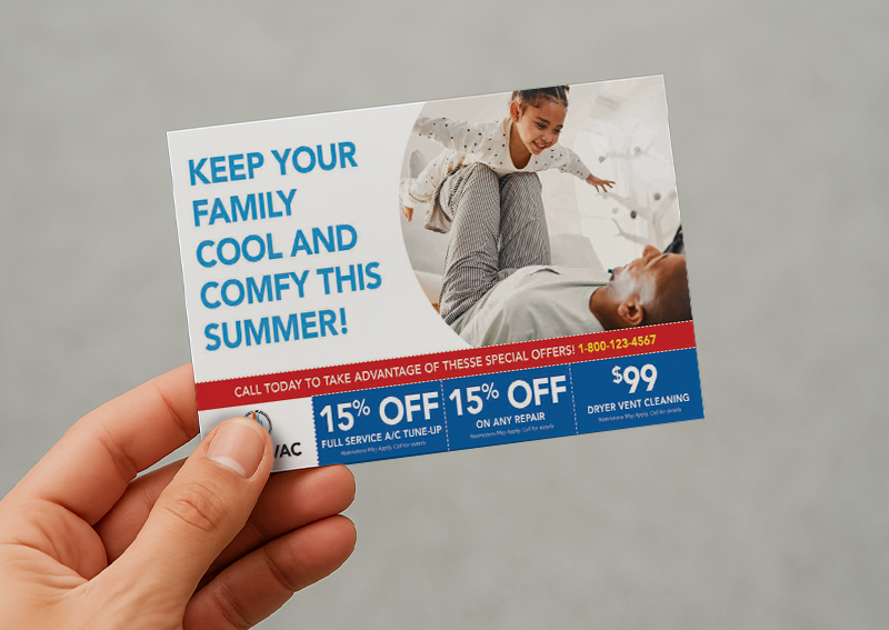 Hand holding an HVAC promotional postcard