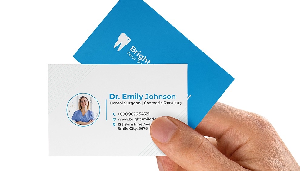 Hand holding a dentist business card